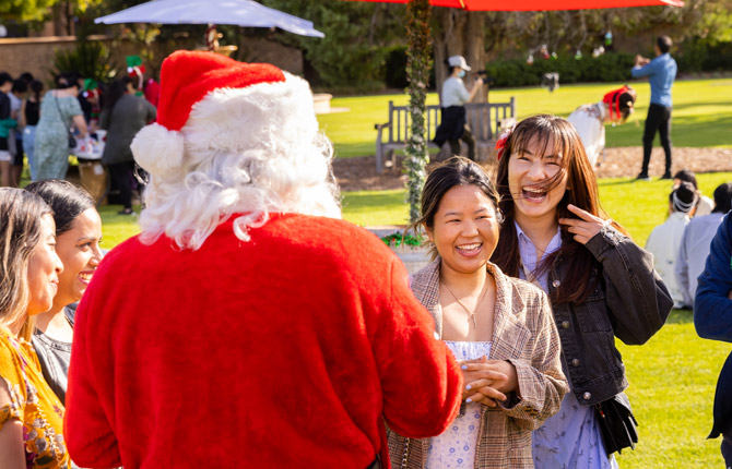 Santa greeting students at a garden party